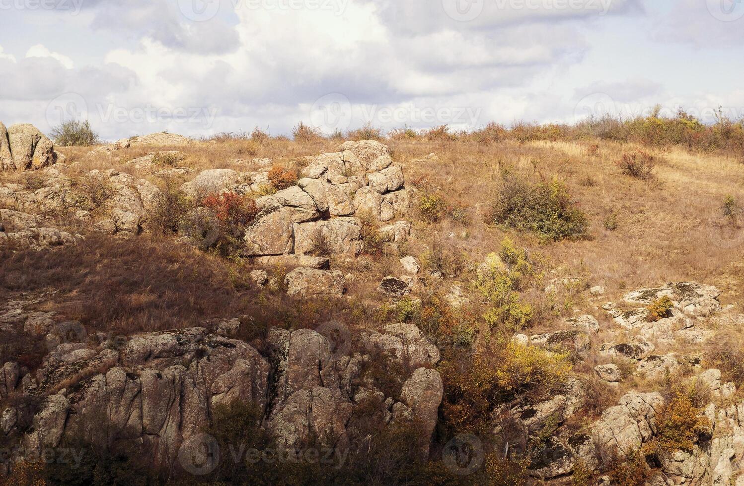 fantastic autumn in a mountain canyon, huge rocks. Mountains of large granite boulders, stone ledges for mountaineering and walking. trees grow among the rocks. Aktovsky Canyon, Ukraine. photo
