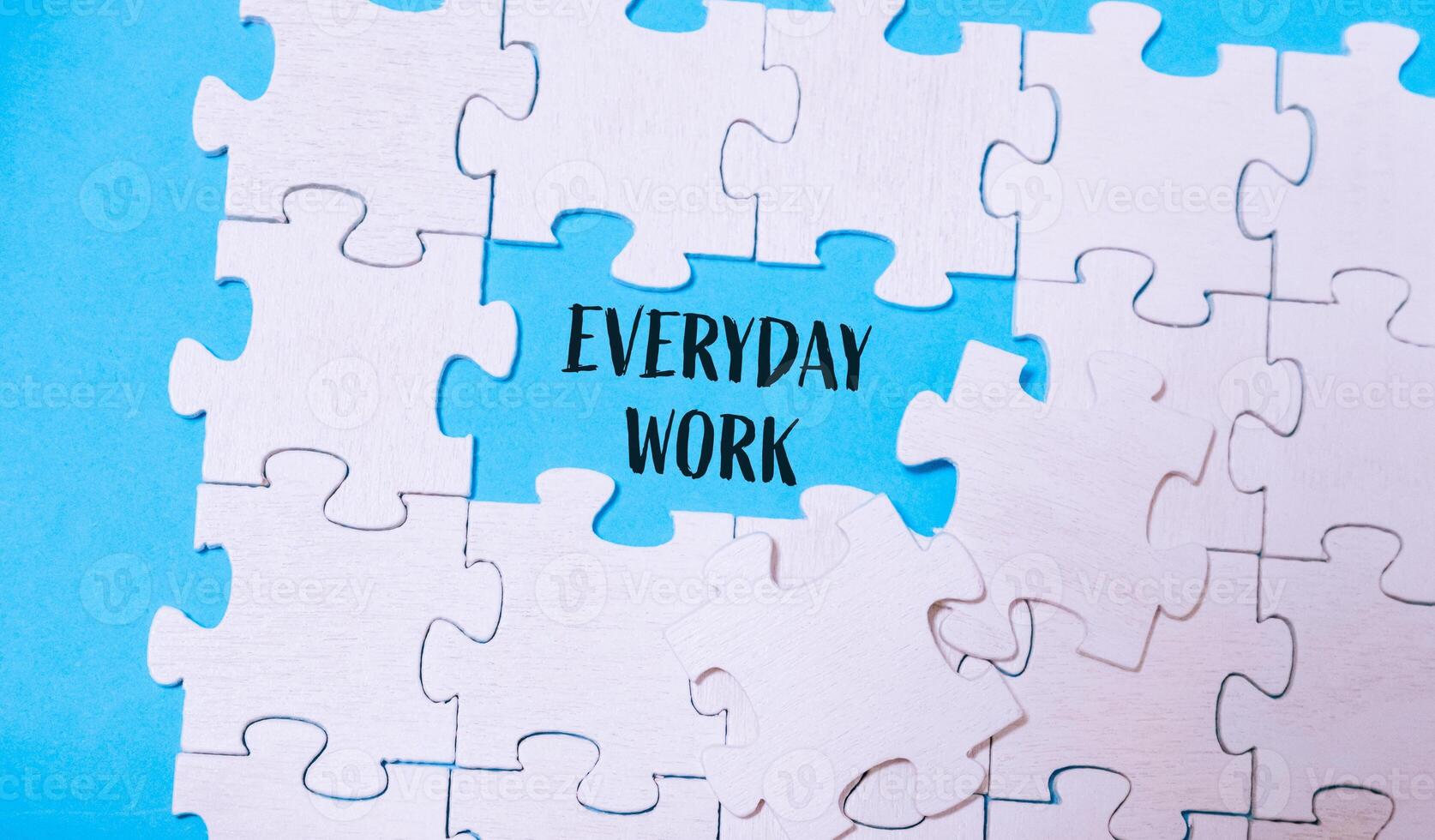Puzzle with the words everyday work written in the middle photo