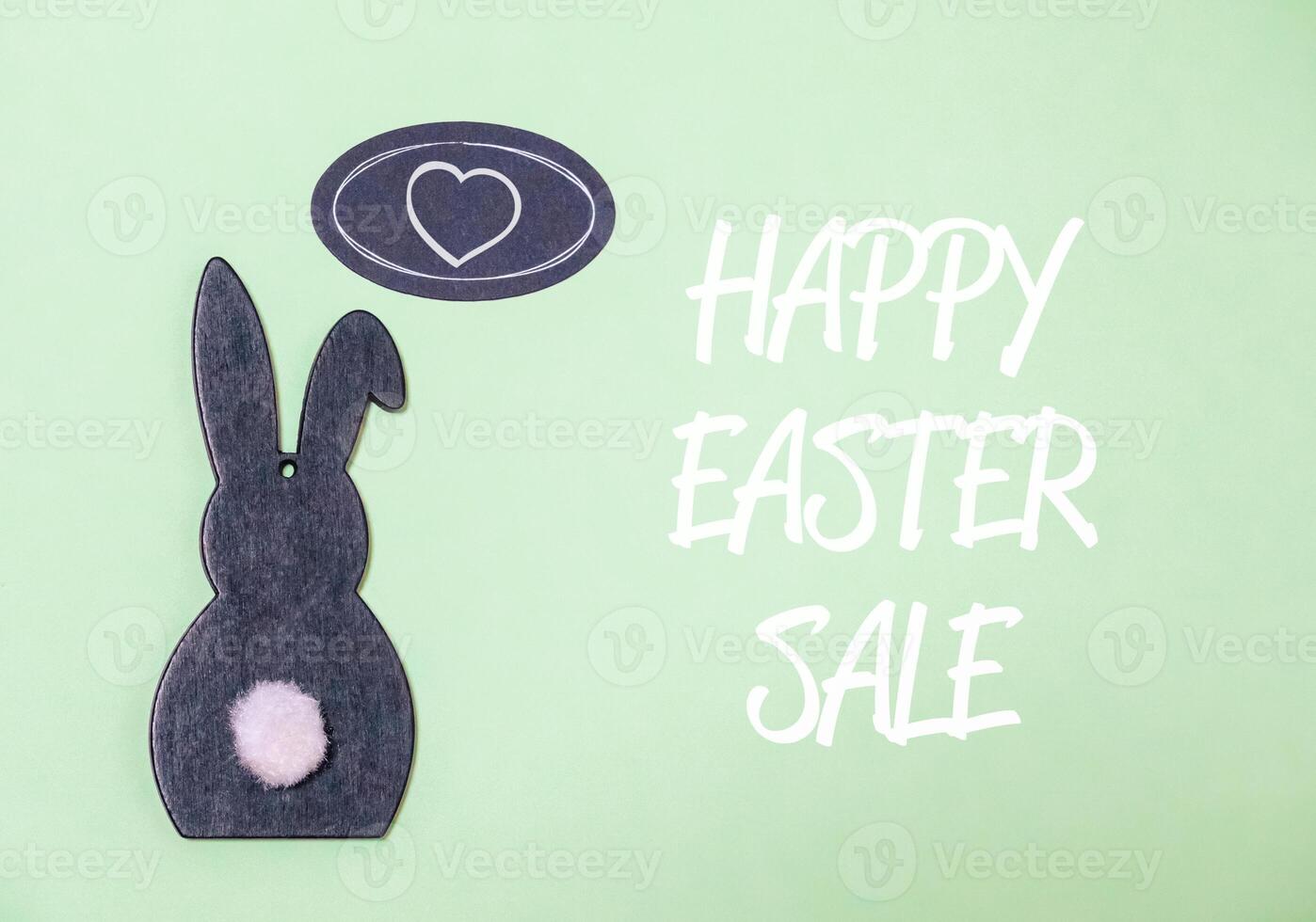 Rabbit is sitting on a green background with a heart in the middle photo
