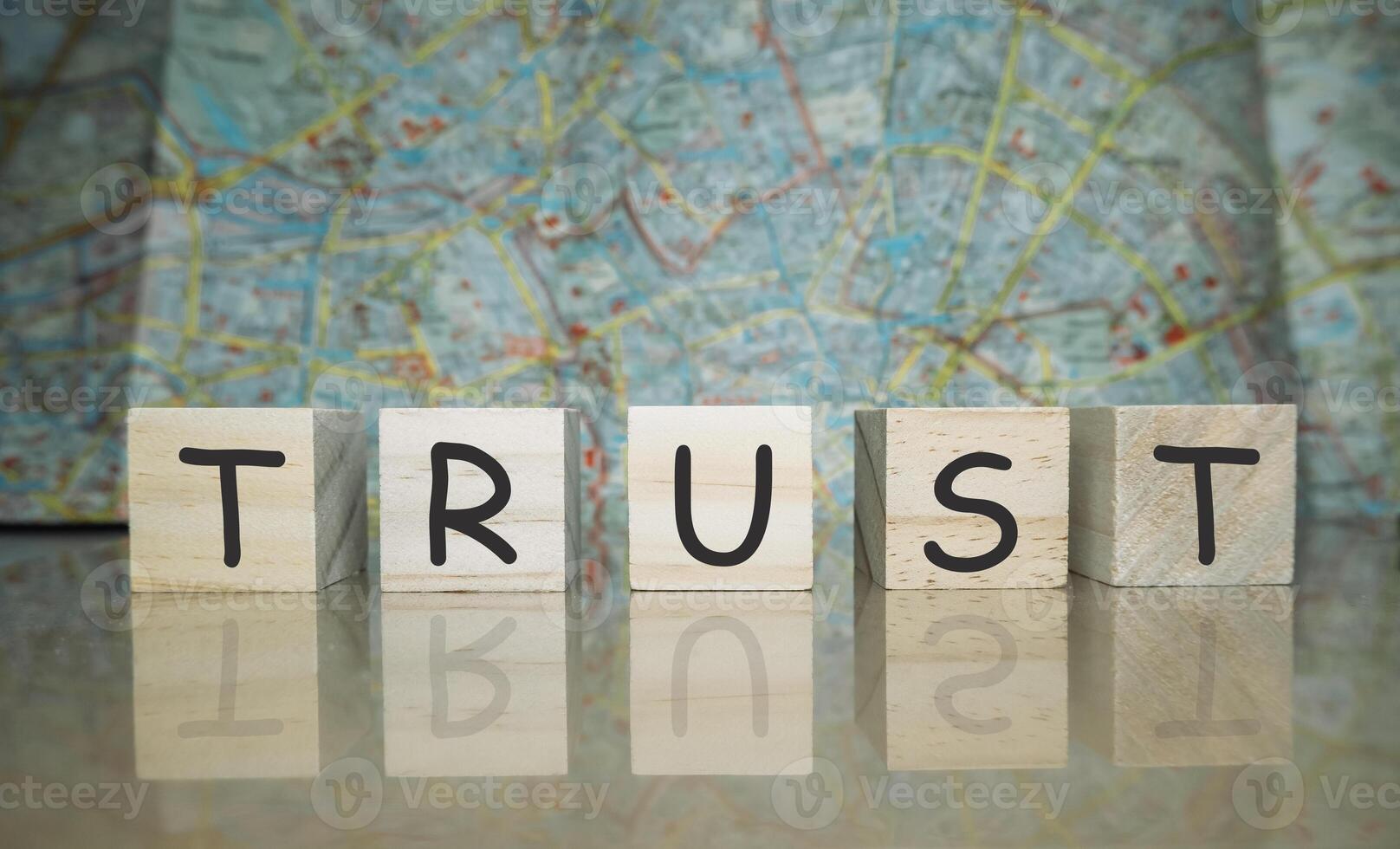 Wooden block with the word trust written on it photo