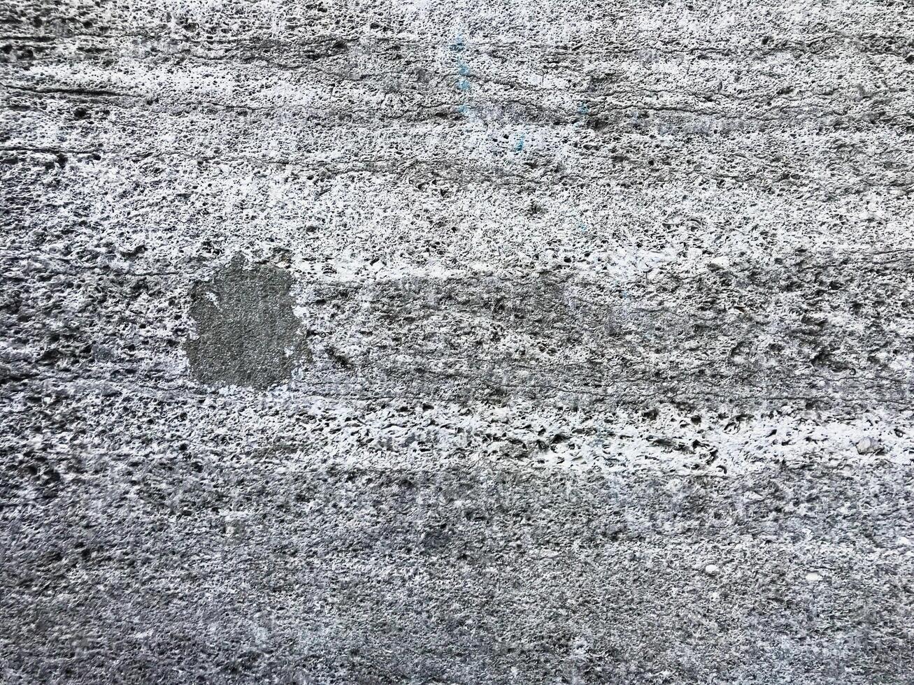 Grey and white wall with a small hole in it photo