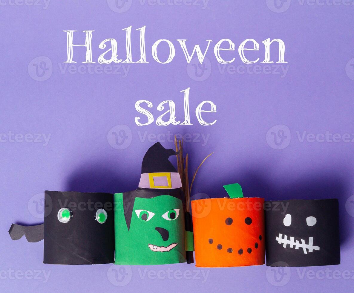 Halloween sale with four paper cutouts of Halloween characters photo