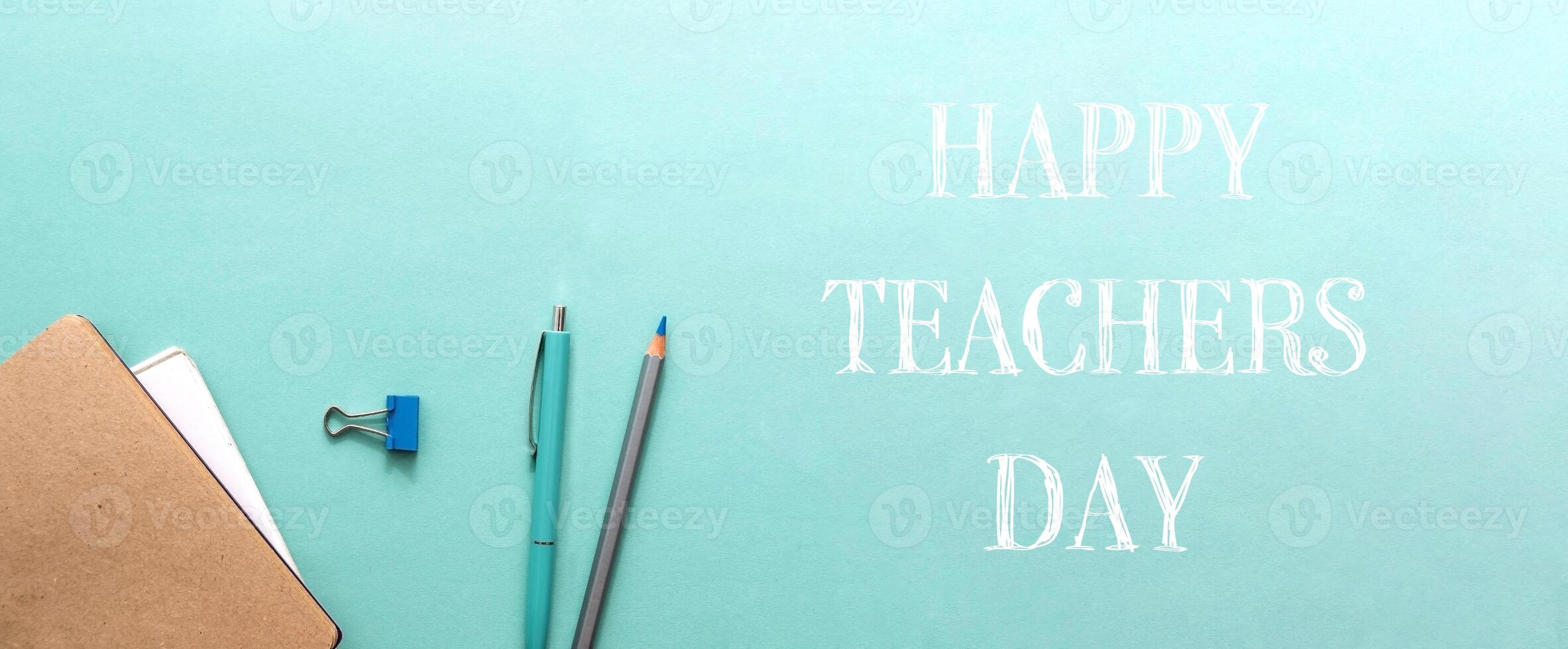 A blue and green pencil and pen on a green background photo