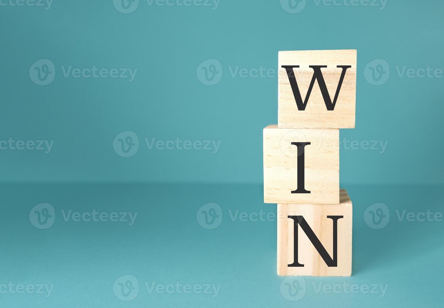 Stack of wooden blocks with the word WIN written on them photo