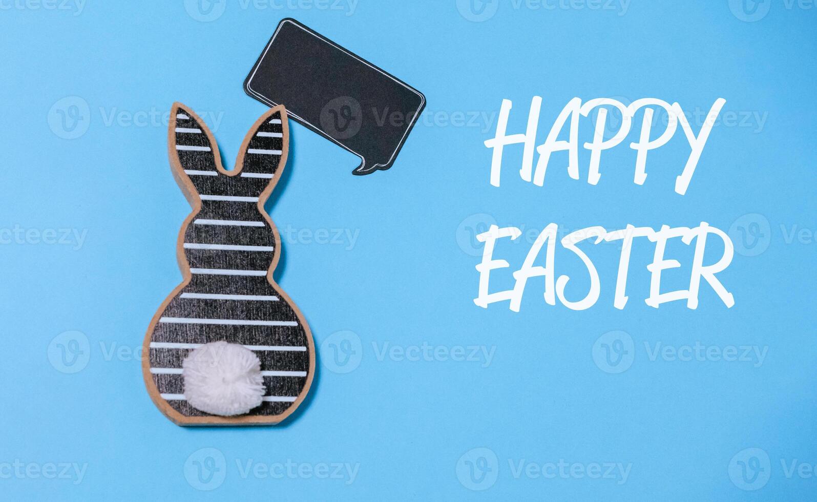 Rabbit is holding a chalkboard with the words Happy Easter written on it photo