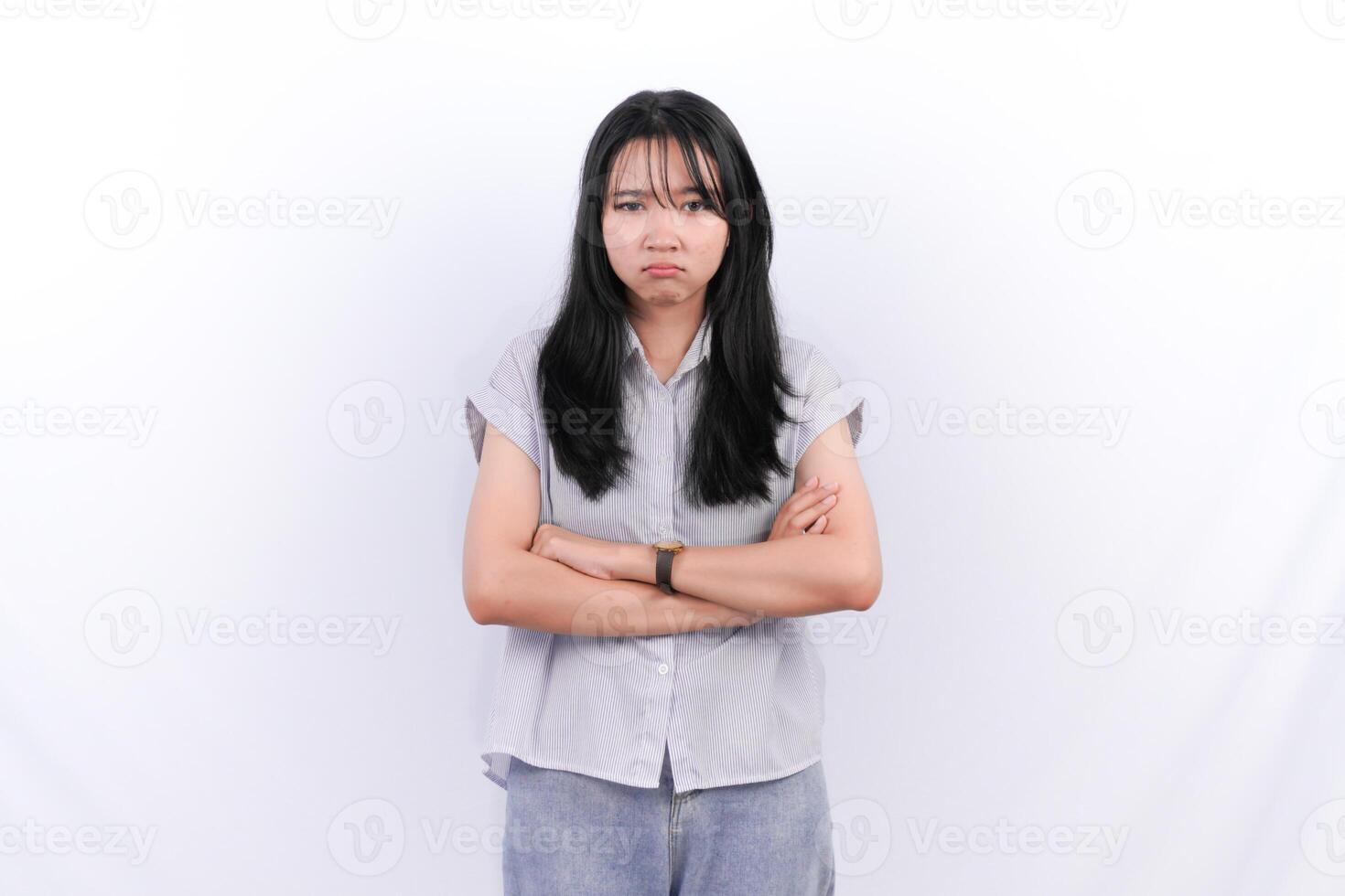 a woman with her arms crossed standing in front of a white background photo