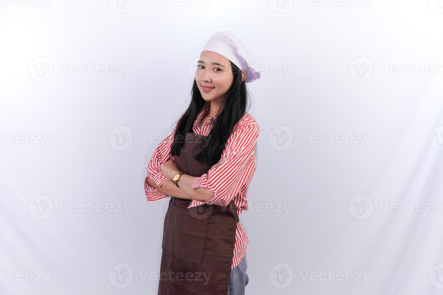 a woman wearing an apron and hat posing for the camera photo