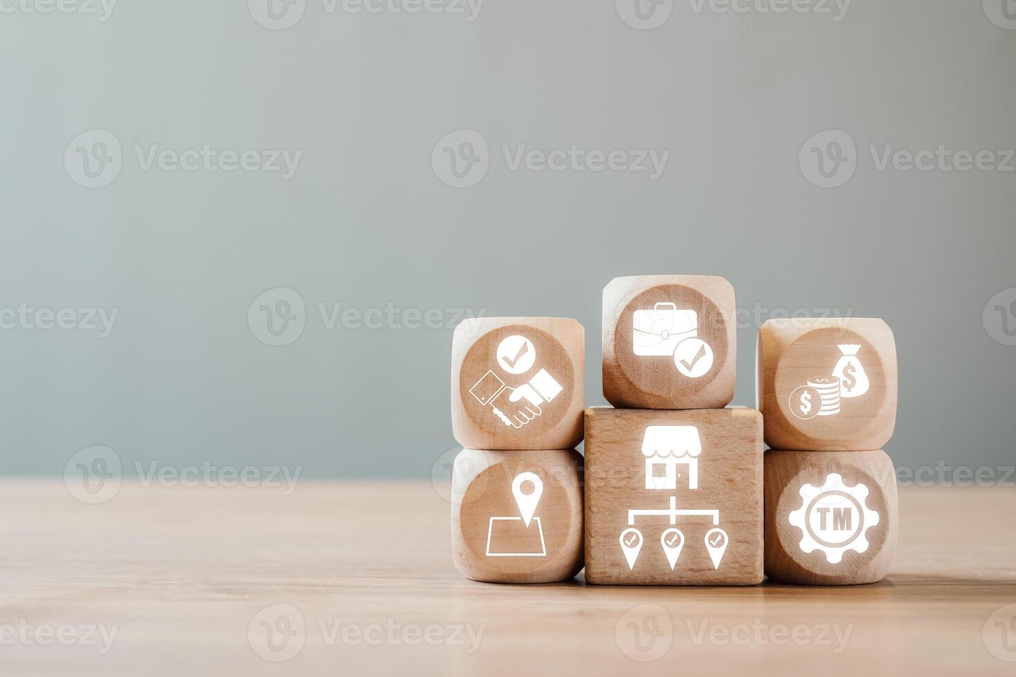 Wooden blocks with business icons representing franchise concepts, ideal for illustrating modern entrepreneurship and brand growth. photo