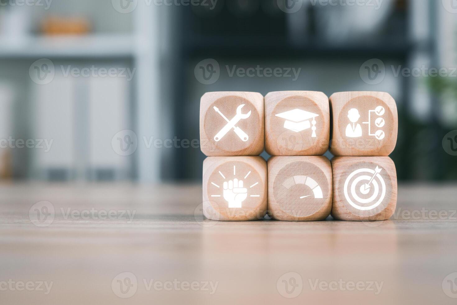 Wooden blocks with icons symbolizing apprenticeship, showcasing tools, education, and goals on a wooden surface. photo