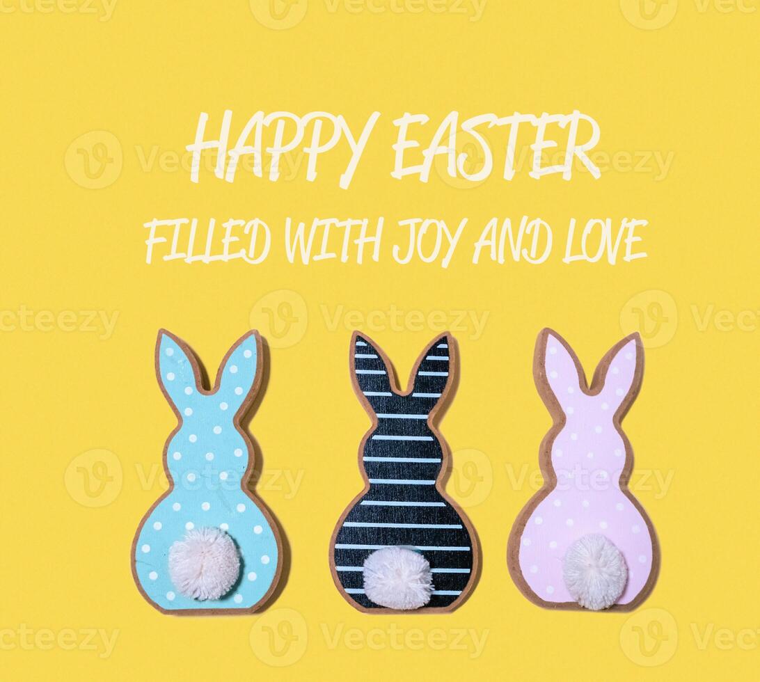Three Easter bunnies with a yellow background photo