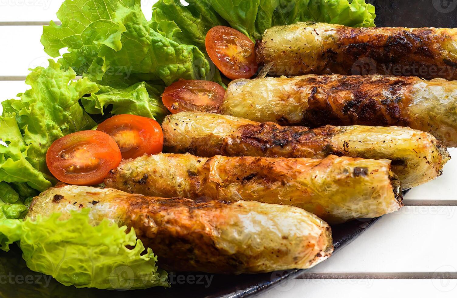 Traditional fried vietnamese spring rolls with pork rice paper on black background side view photo