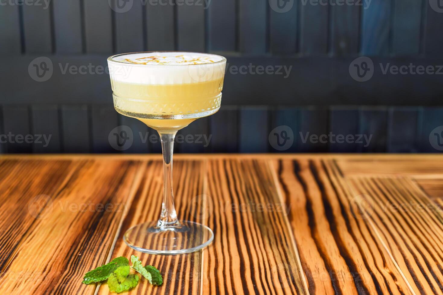 Alcohol cocktail Whisky sour on wooden table photo