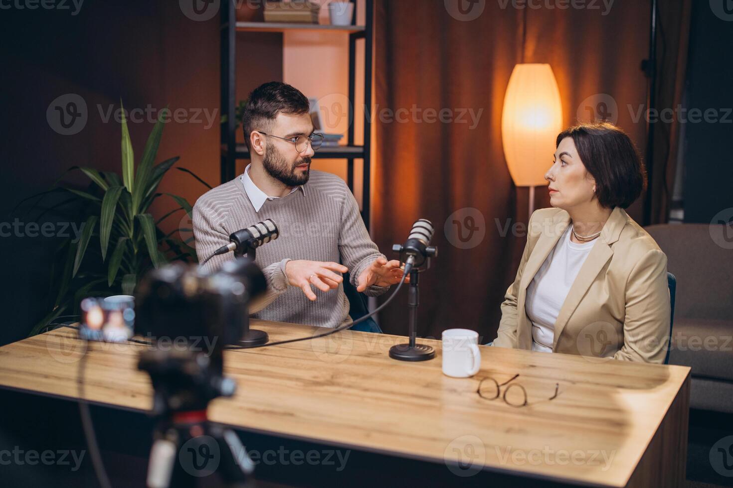 Man and woman collaborating as podcasters, recording engaging audio and content in a modern home studio environment photo