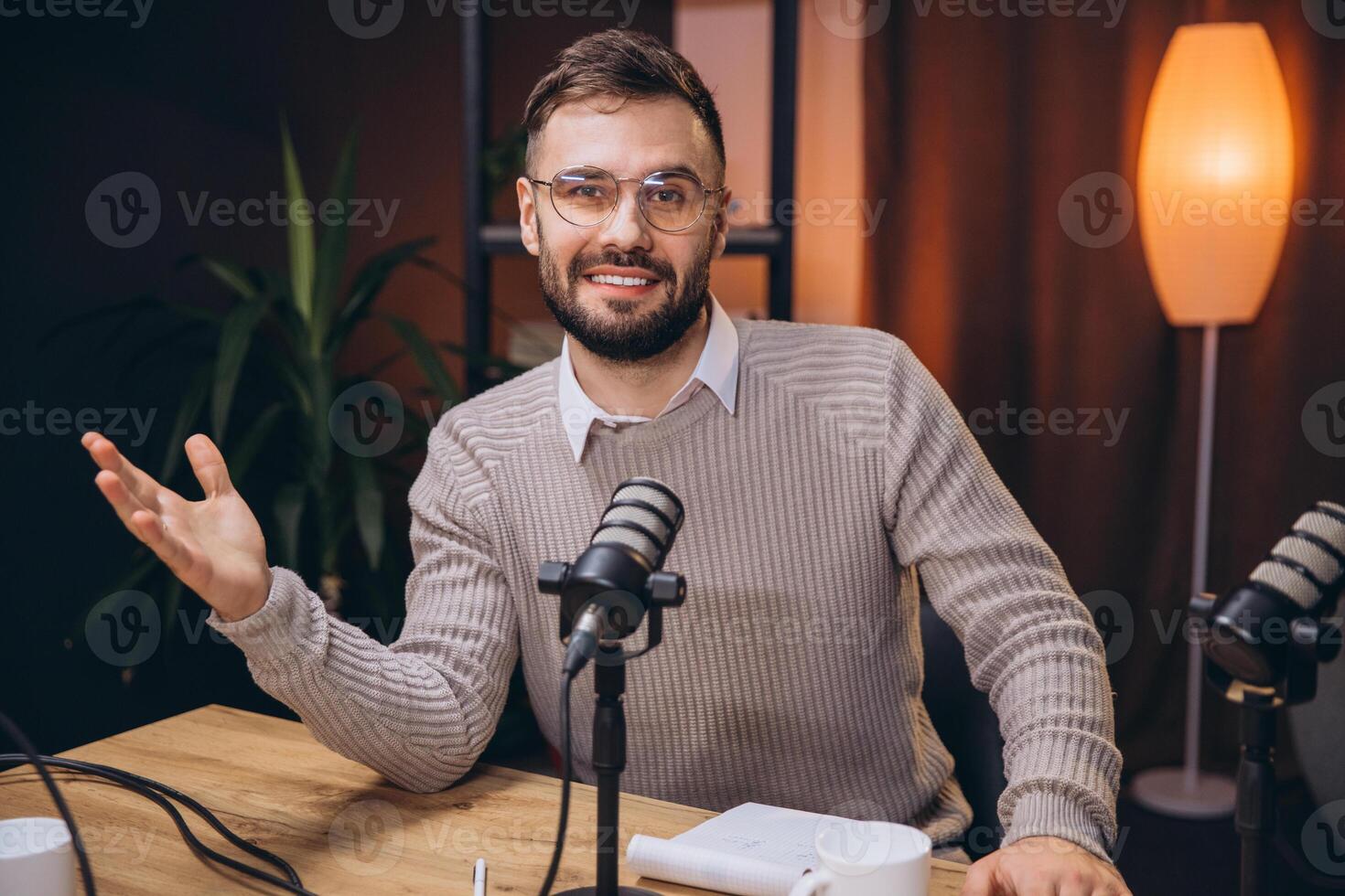 Professional audio engineer recording podcast, speaking into microphone in soundproof studio, capturing engaging vocal content photo