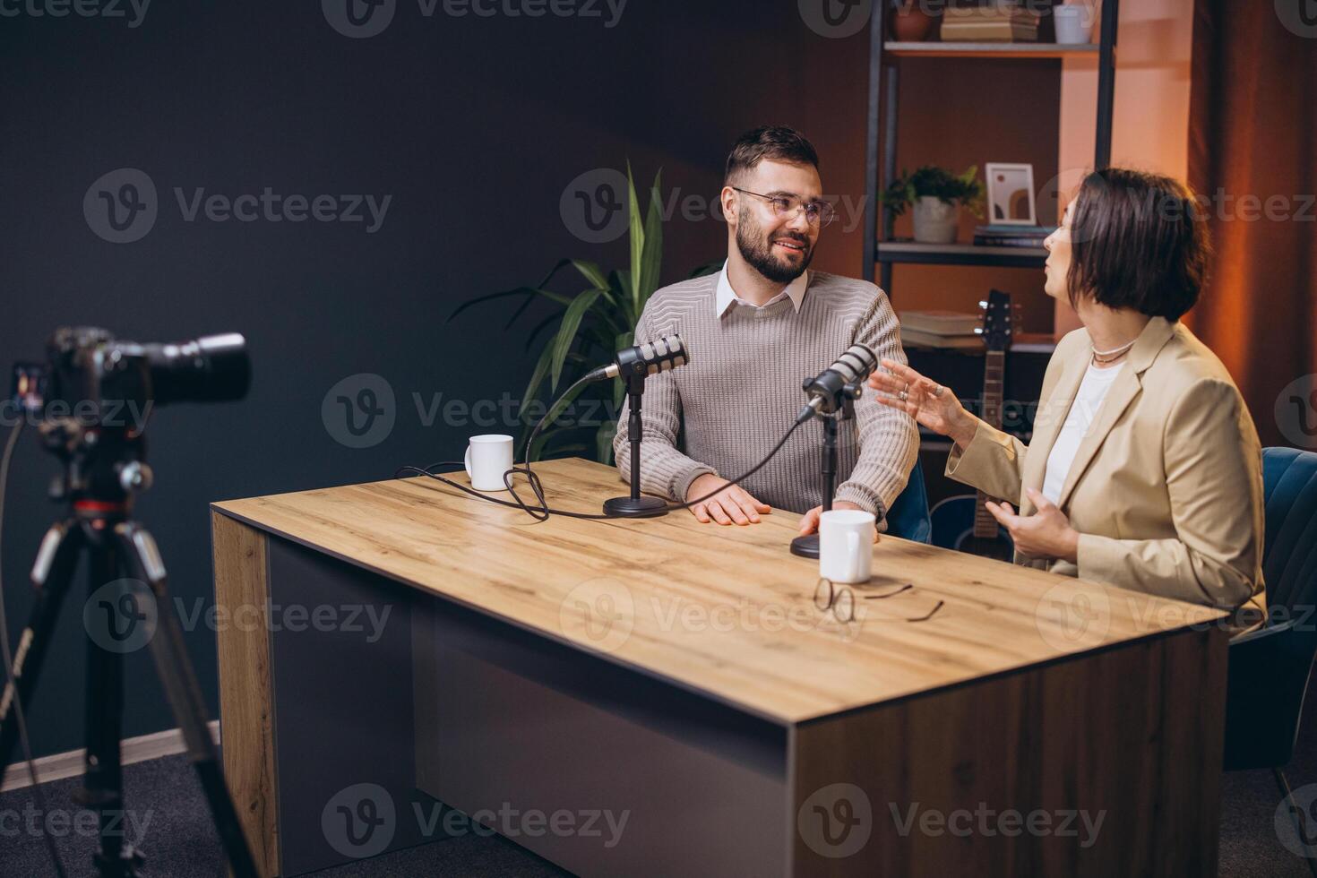 Two content creators recording a podcast episode in a professional studio, discussing and sharing their expertise photo