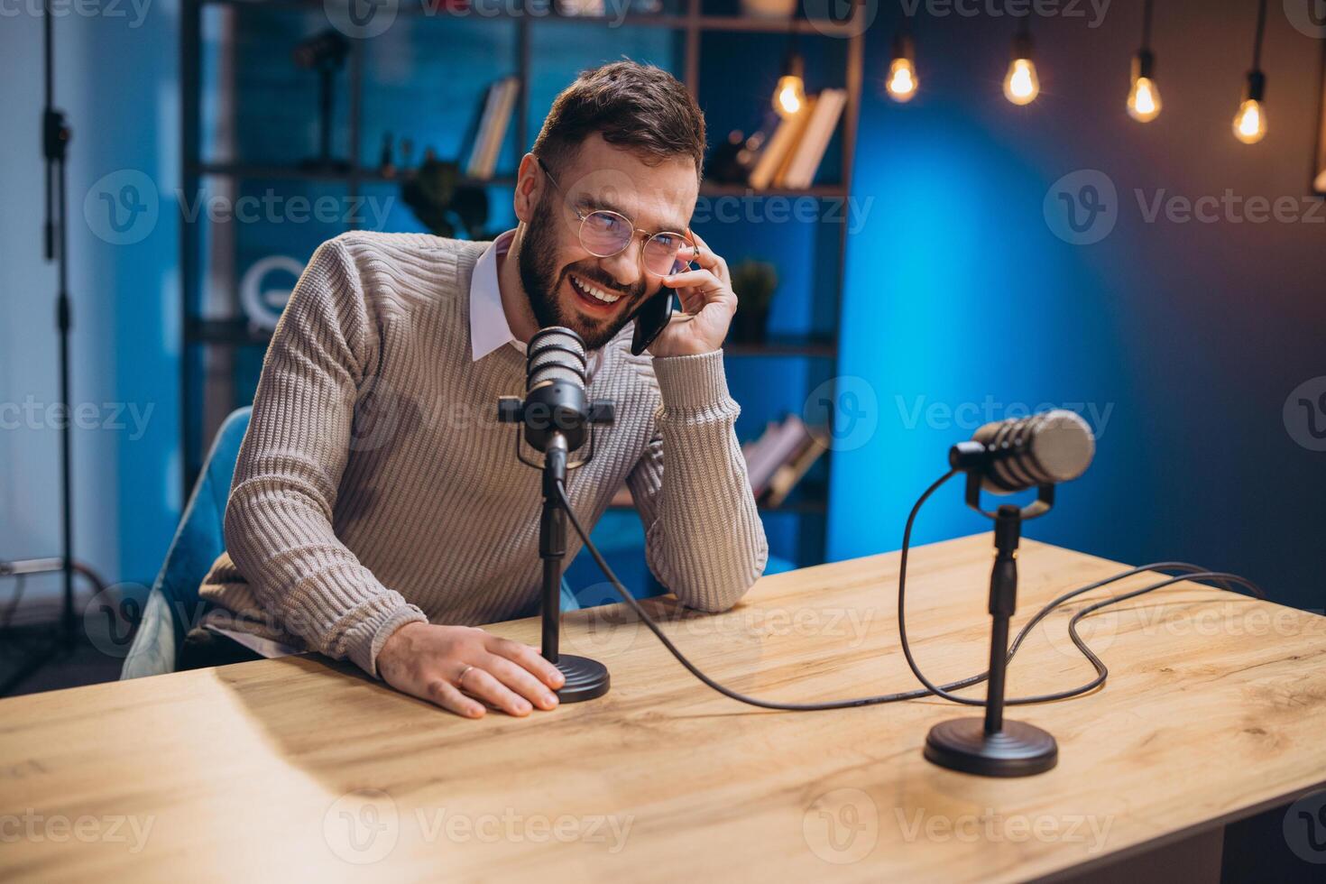 Energetic podcaster speaking into microphone during recording session, capturing professional audio content in sleek home studio environment photo