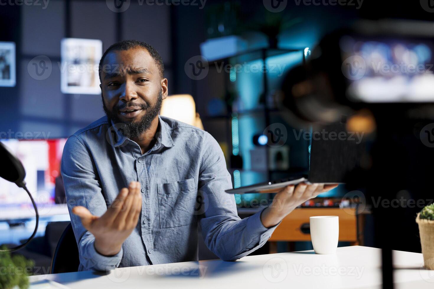 African american content creator filming tech tutorial on how to repair laptop error and preserve internal components. TEch expert teaching subscribers to install operating system on notebook photo