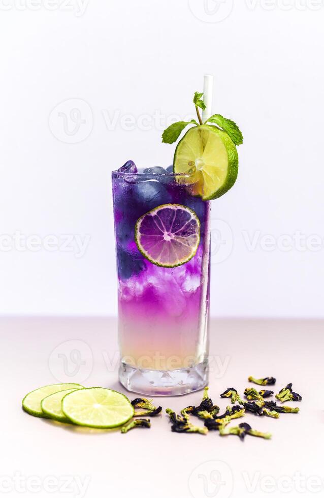Lemonade with butterfly pea flowers and blue syrup on gray background with copy space photo