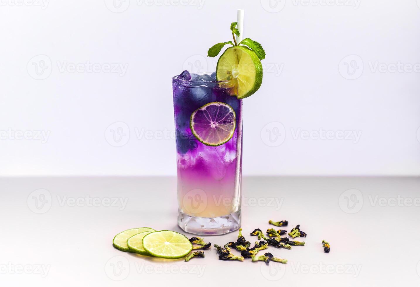 Lemonade with butterfly pea flowers and blue syrup on light gray background with copy space photo