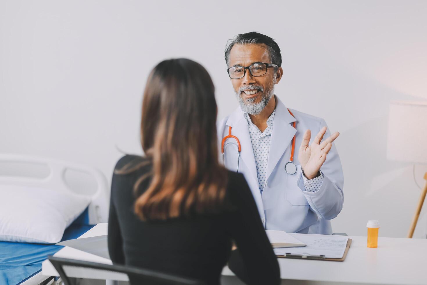 A doctor talking to a patient in a hospital room photo