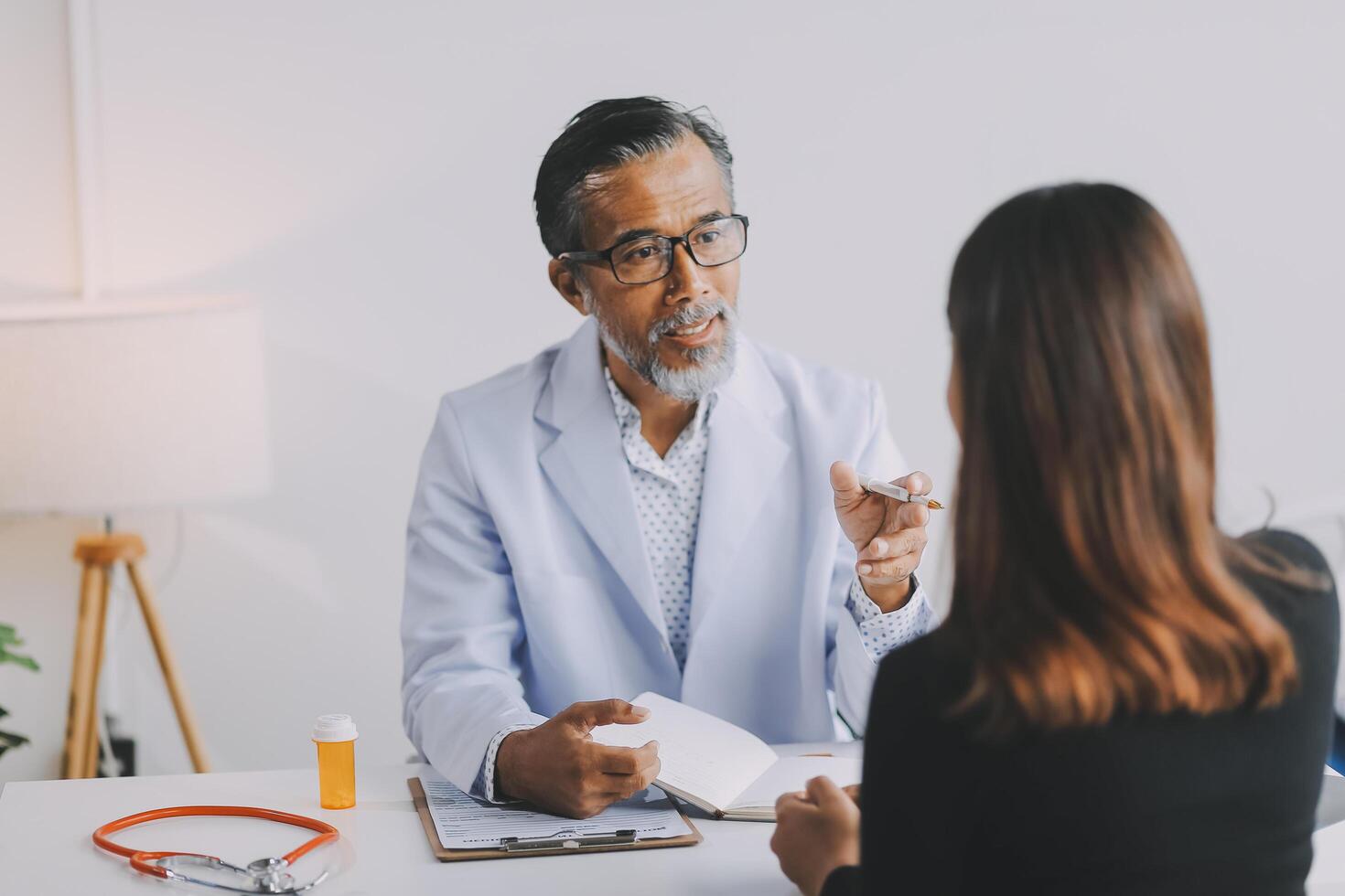 A doctor talking to a patient in a medical office photo