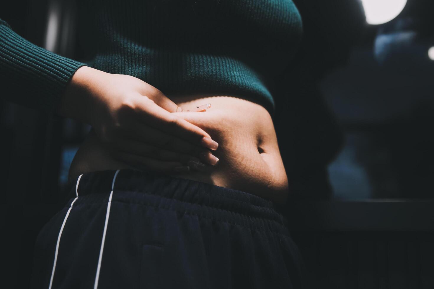 A woman with her stomach showing off her abs photo