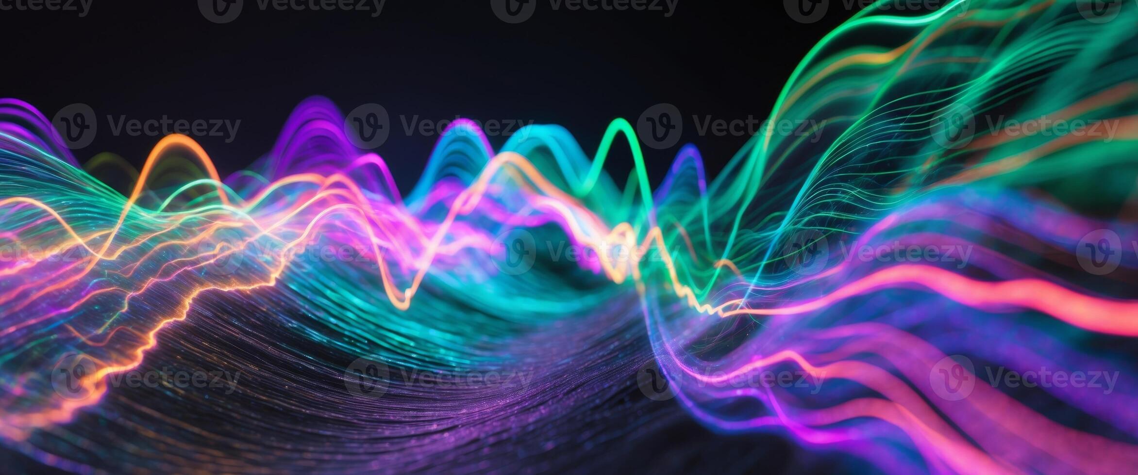 Colorful waves of light create an abstract and energetic visual display in the dark. photo