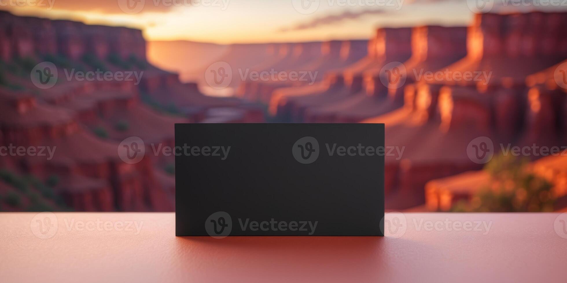 Black business card showing a colorful canyon illuminated by setting sun photo