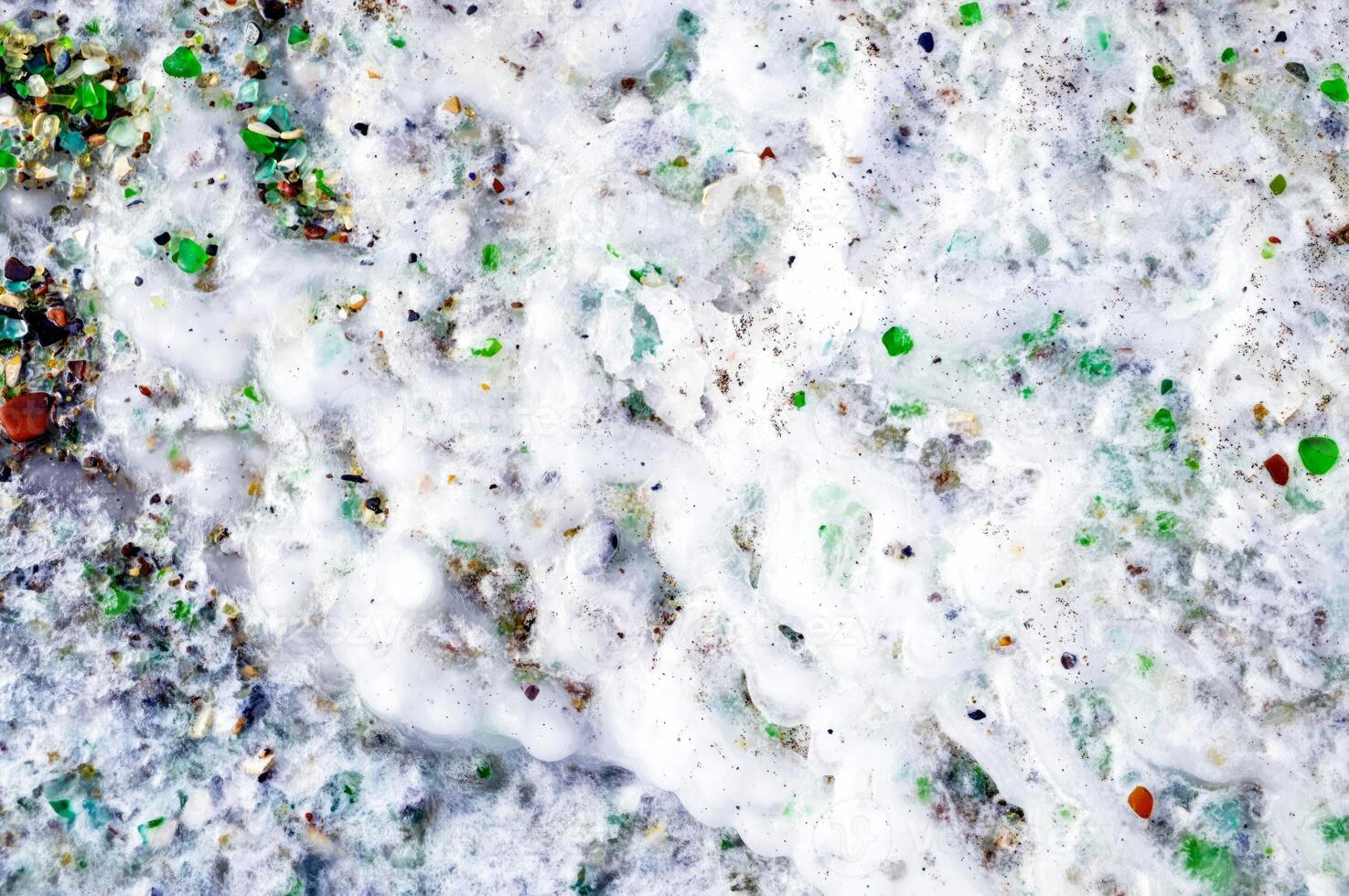 Background ice with multi colored glass. Glass beach, Japanese sea, Russia. photo