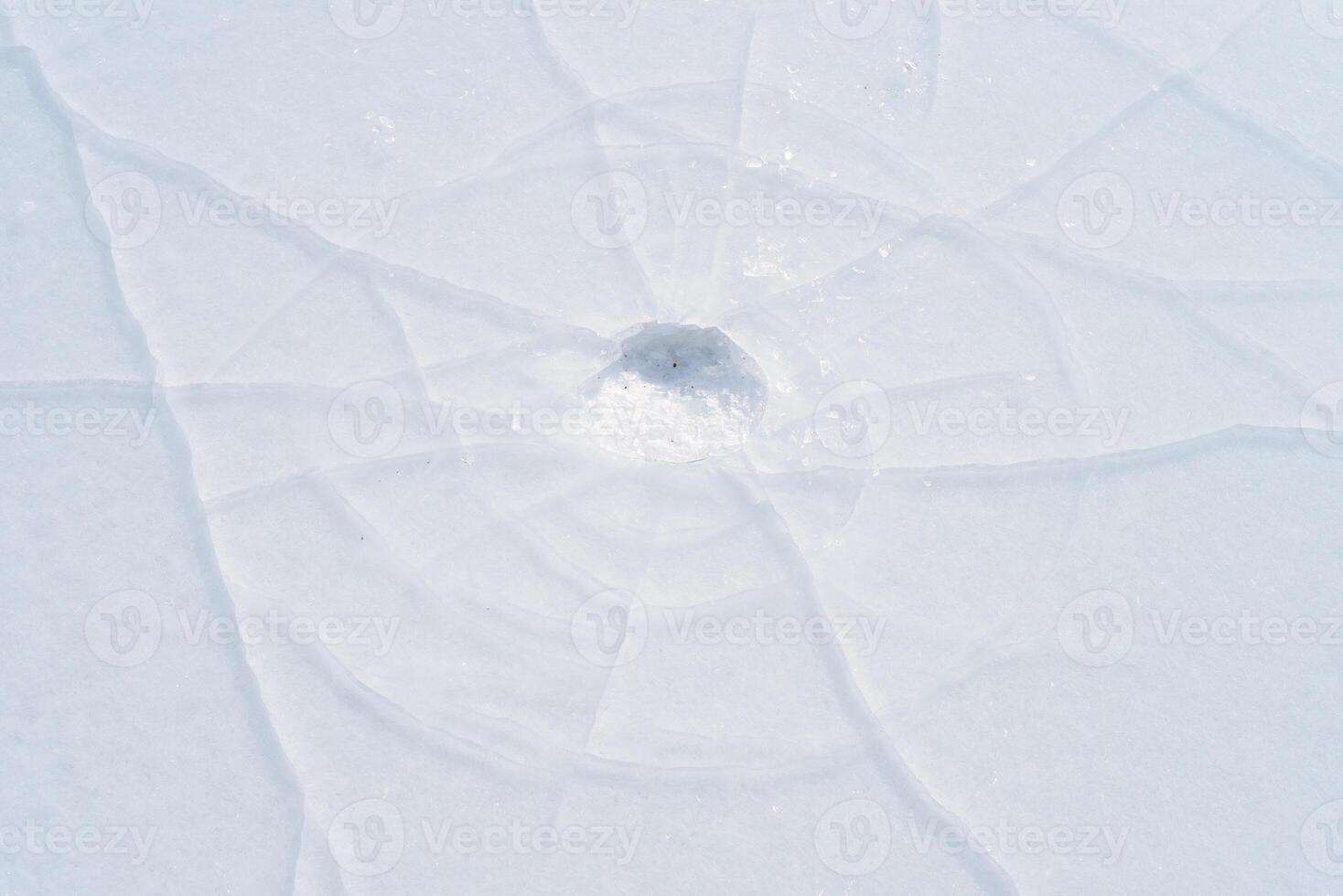 Cracks in the ice of a frozen river in winter photo