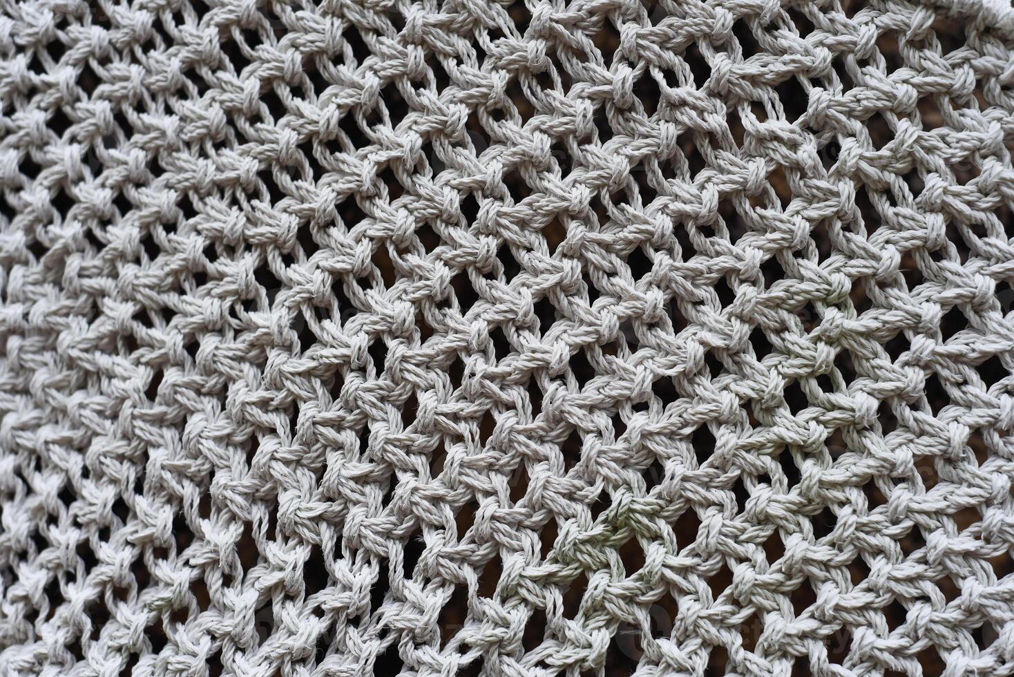 Various knots of macrame technique made of white thread photo
