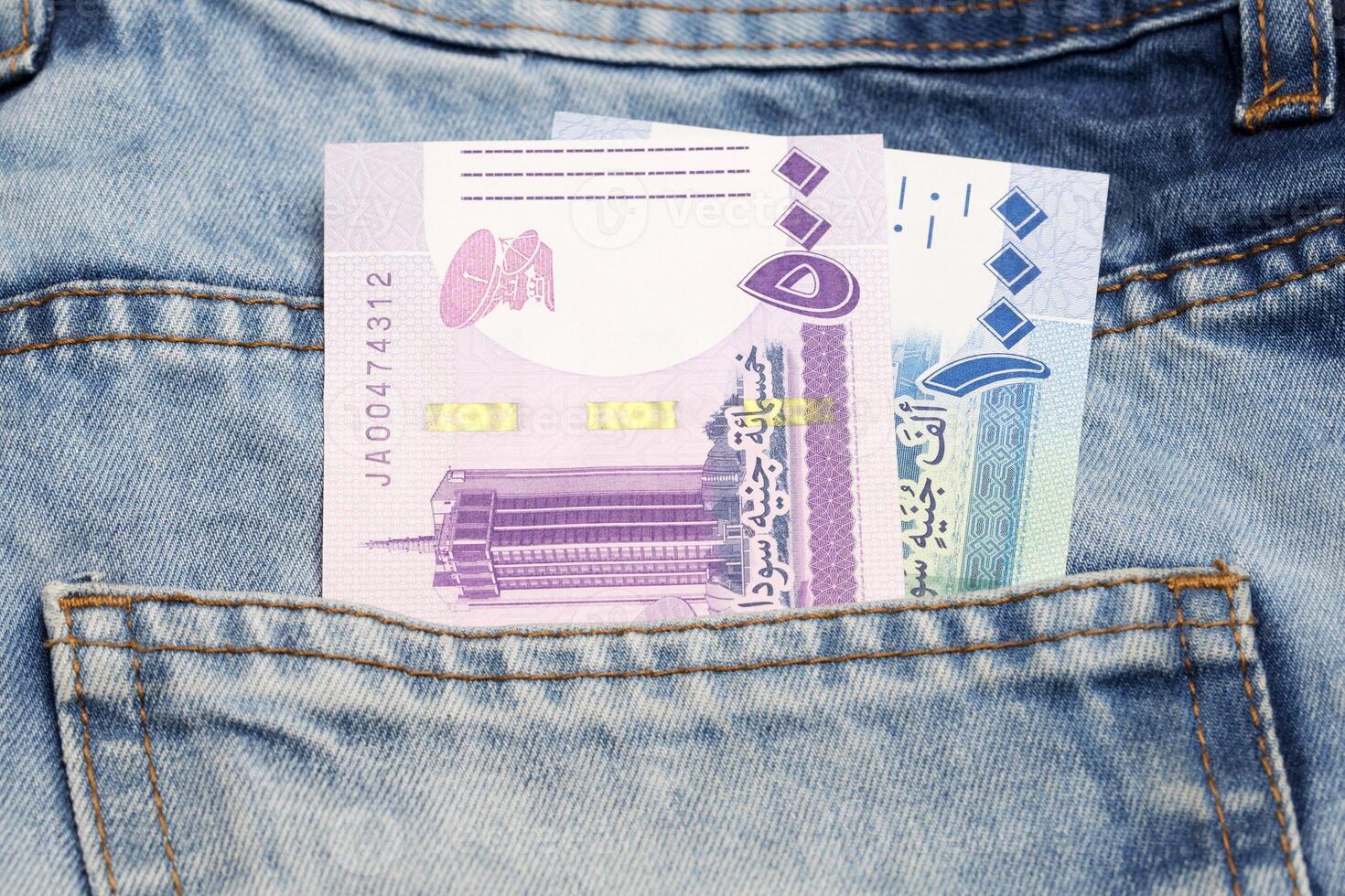 Sudanese Pound in the pocket of blue jeans photo
