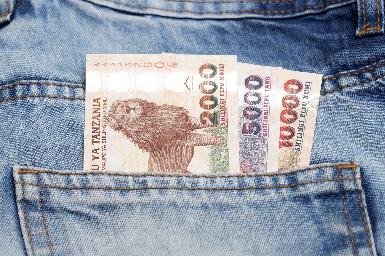 Tanzanian money - shilling in the pocket of blue jeans a business background photo
