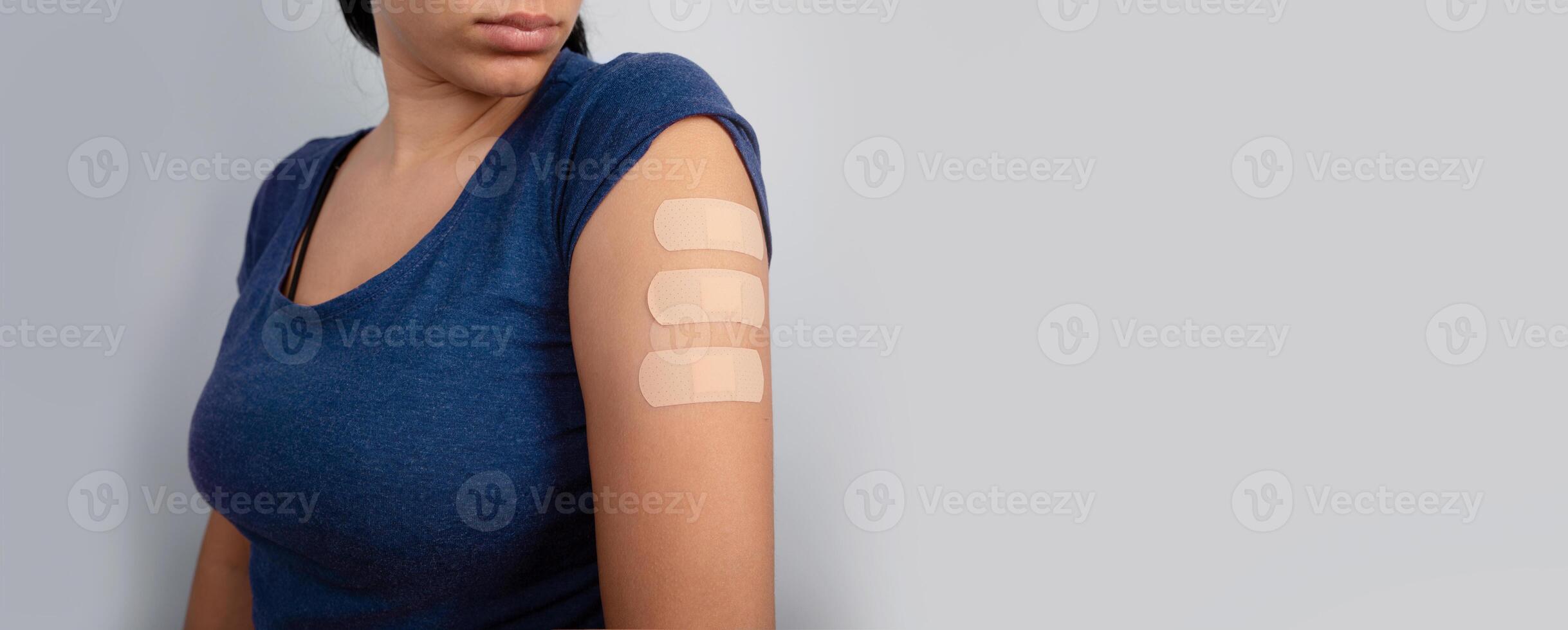 woman showing medical patch after vaccine photo