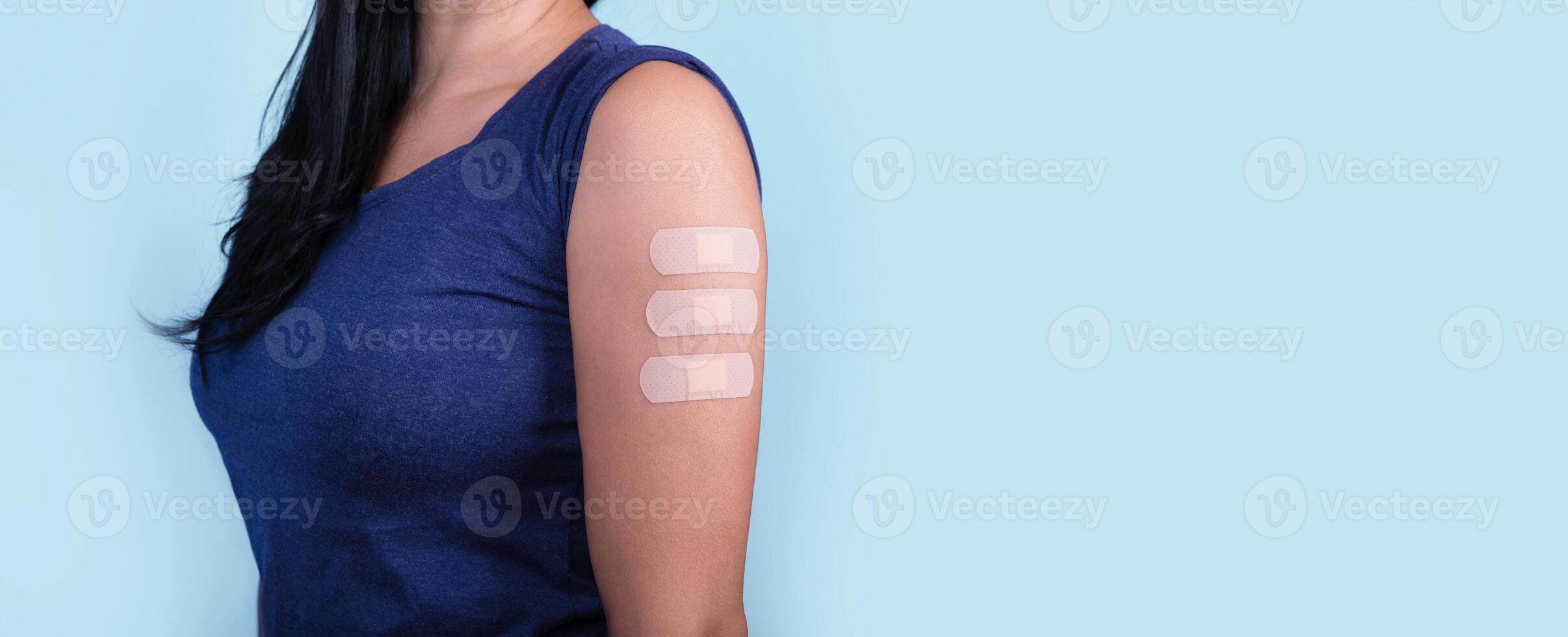 woman showing many plasters on shoulder photo
