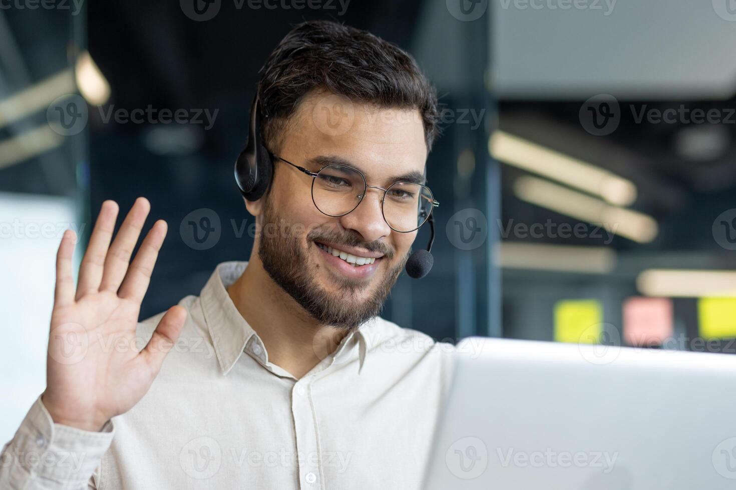 Man with headset and laptop inside office. Online customer support worker talking using call. Businessman close up on business meeting conference with colleagues. photo