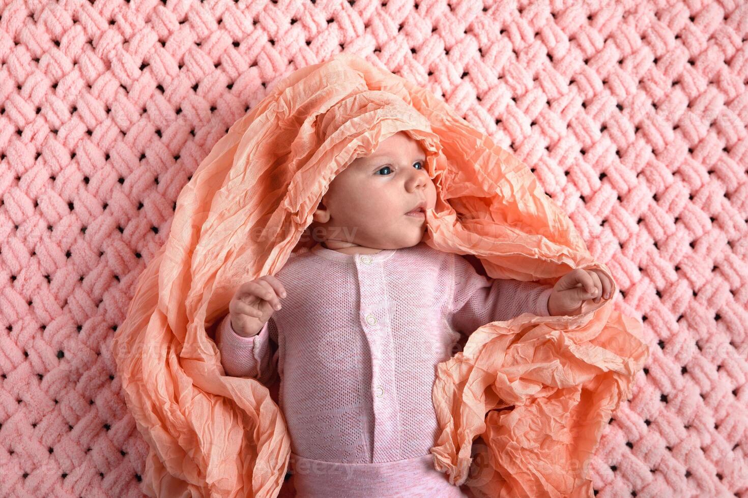 baby in a pink suit photo