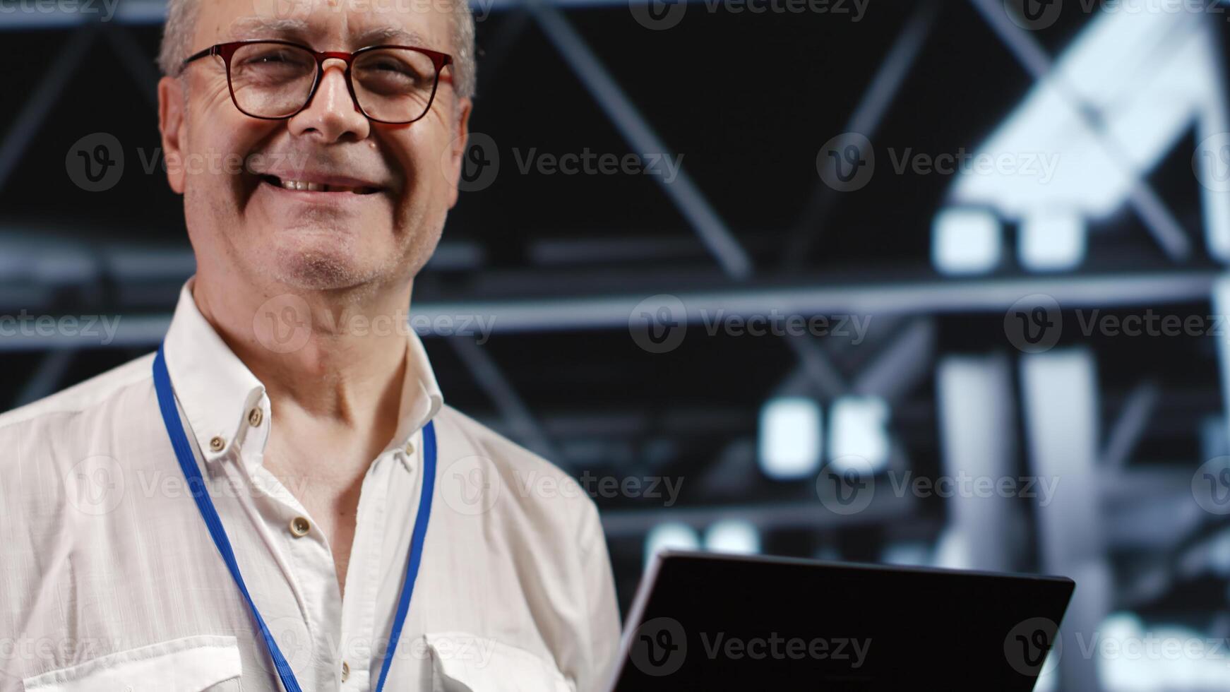 Adept IT professional navigating network of servers in industrial workspace. Engineer with laptop in hand ensuring seamless operations, doing optimizations and maintenance in data center photo
