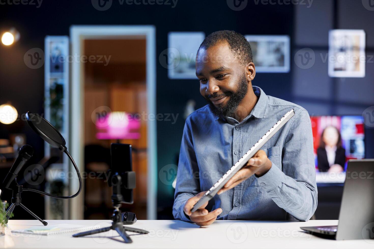 African american man filming keyboard disassembly guide doing tutorial on how to do maintenance. Technology internet show host teaching subscribers how to clean and fix individual keyboard keys photo