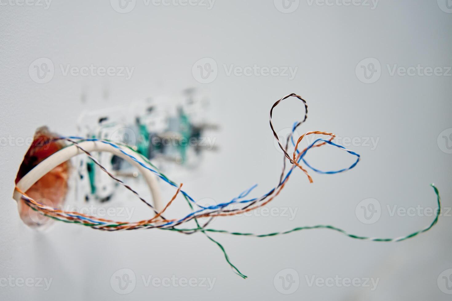 Exposed network cables in wall socket during repair photo