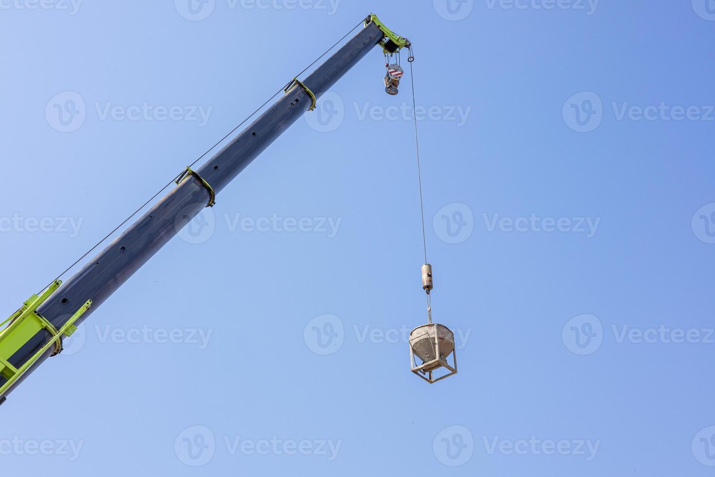Tower Cranes on Residential buildings Construction, Construction site, Construction of Multi Storey Residential Building, Tower Crane on formworks, Construction of Skyscrapers, Blue sky background. photo