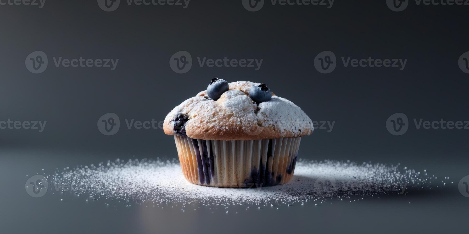 Fresh blueberry muffin dusted with powdered sugar on dark background. photo
