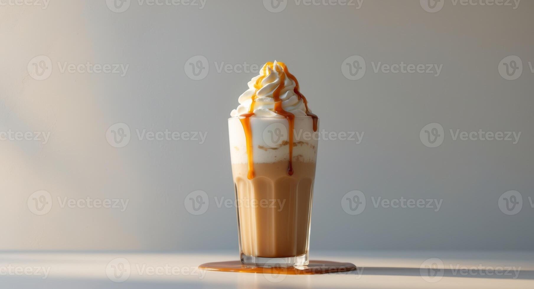 Tall caramel milkshake with whipped cream and caramel drizzle photo