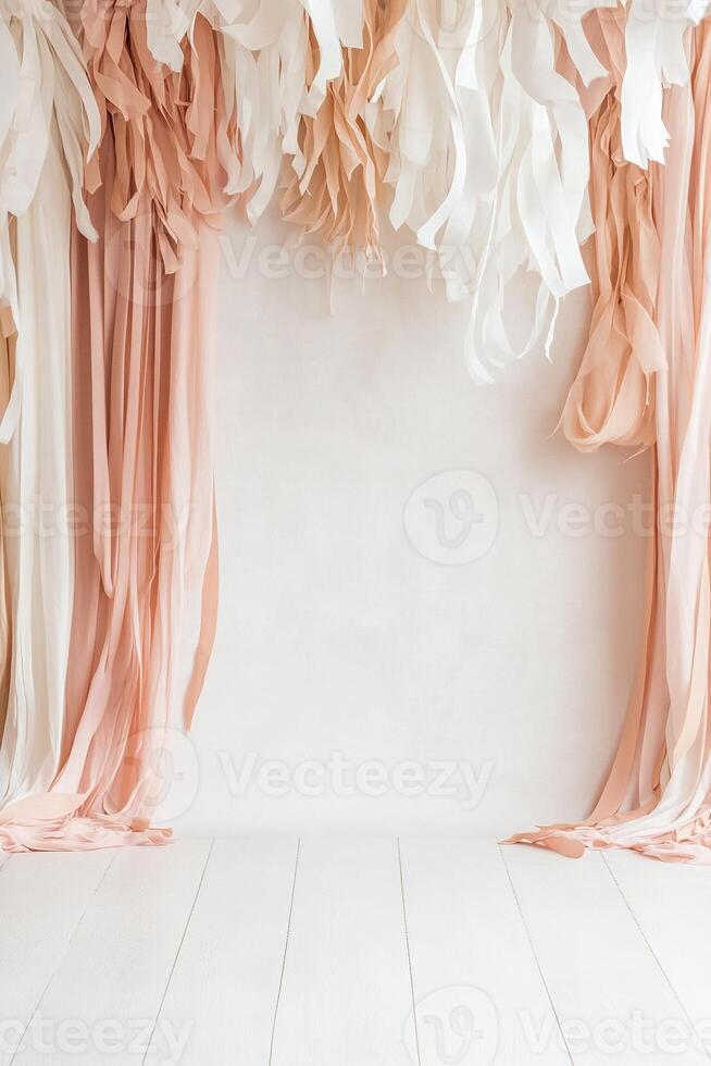 Soft pastel pink backdrop adorned with flowing streamers in white and blush tones, providing an inviting space ideal for special celebrations and gatherings. Perfect for photo ops