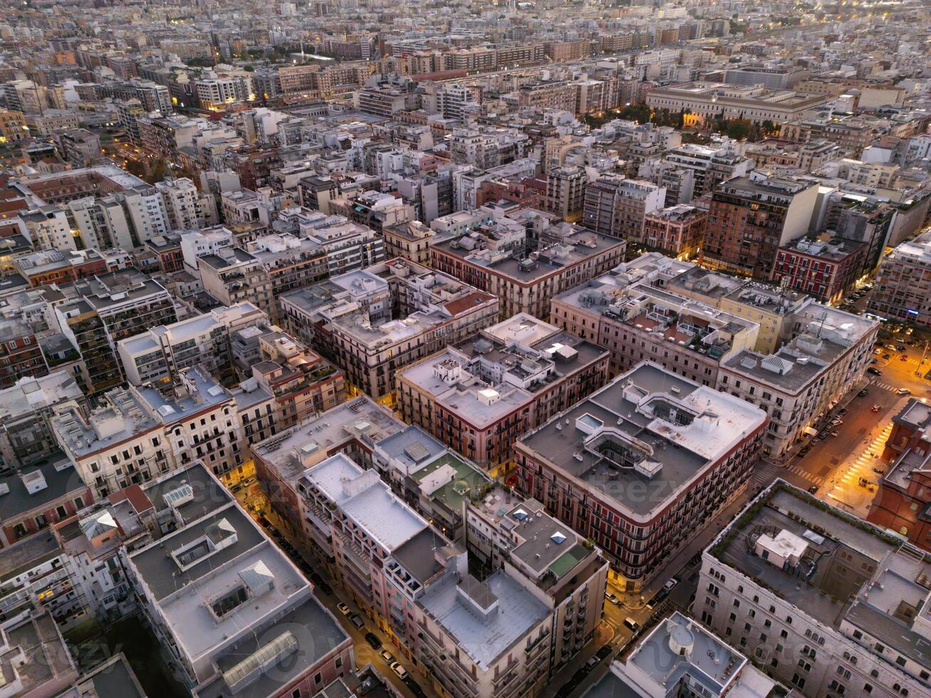 Drone view of city of Bari at night in Italy. lighting of lanterns gives comfort and a sense of calm. A popular place for pilgrims and just tourists. nightlife in Bari is diverse. tourism concept photo
