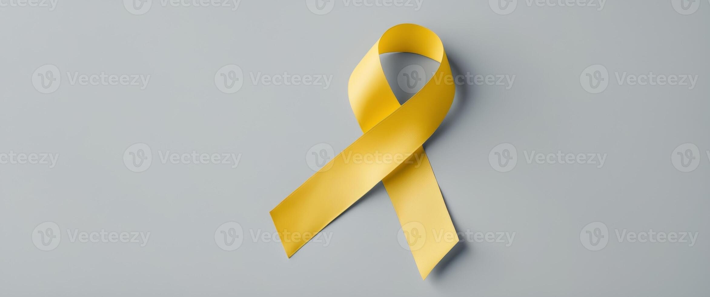 Global Autism Awareness Yellow Ribbon on Gray Background with Space for Text or Messages Promoting Awareness and Support for Autism Spectrum Disorder. photo