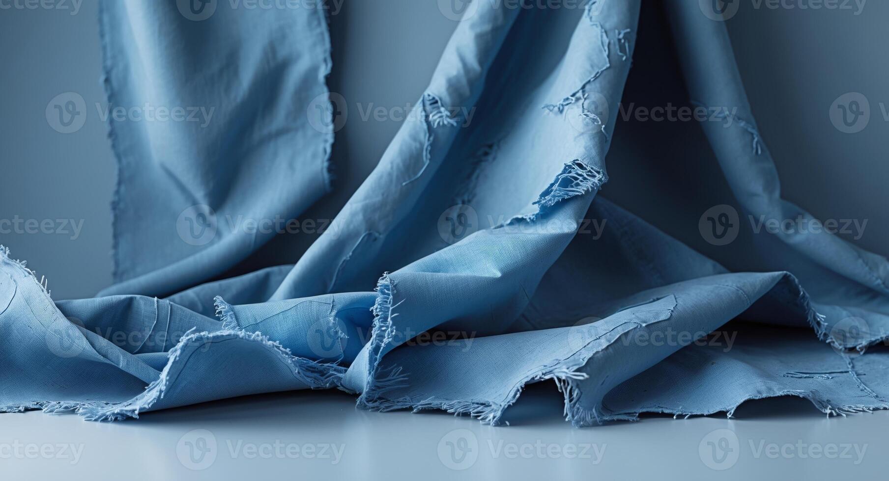 Tattered blue fabric texture with visible fringes and tears. photo