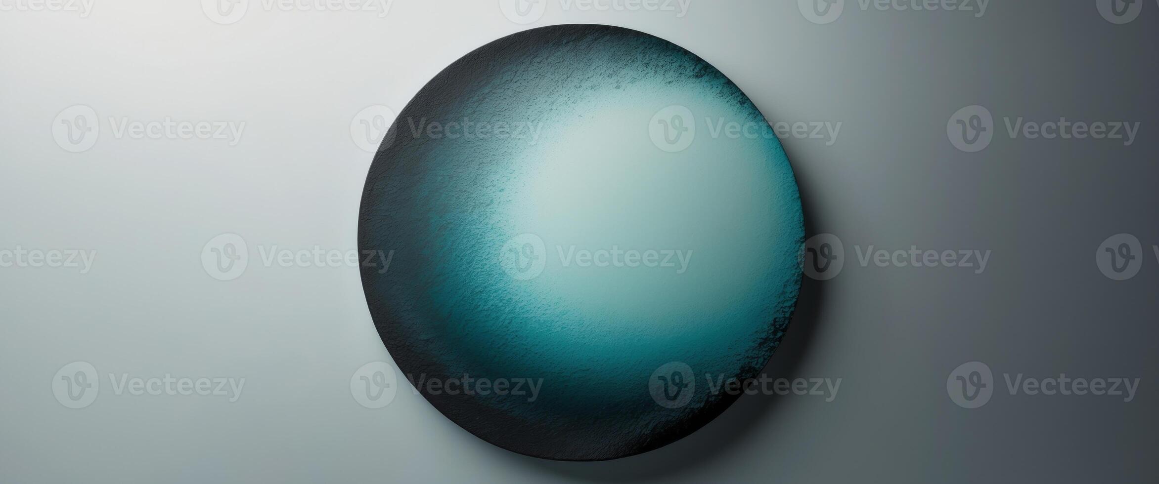 Round gradient with a rough texture going from blue green to charcoal on a see through background photo