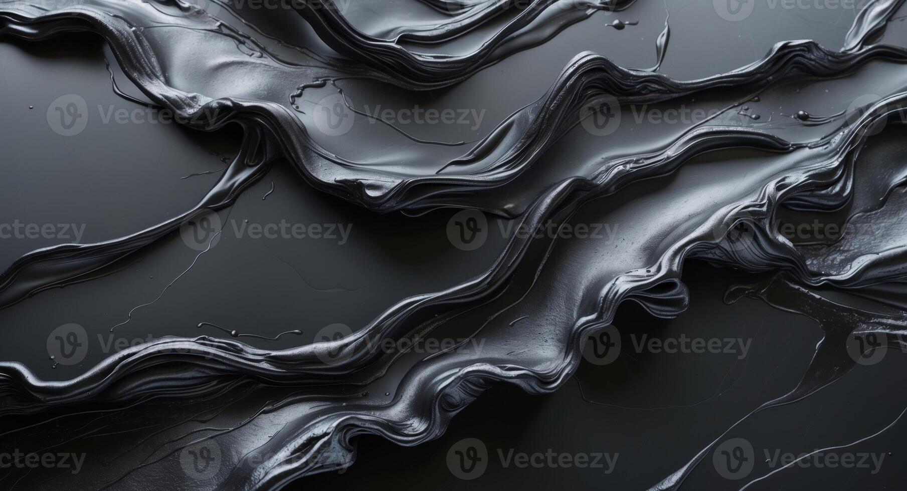 Abstract metallic black substance flowing on dark surface. photo