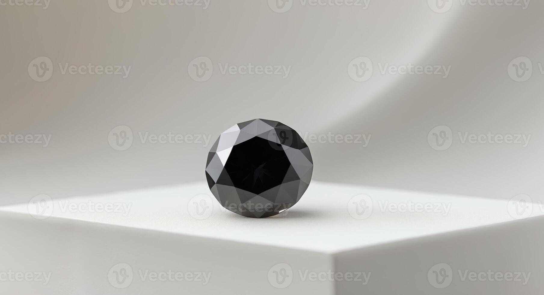 A Single Black Diamond Resting On White Surface. photo
